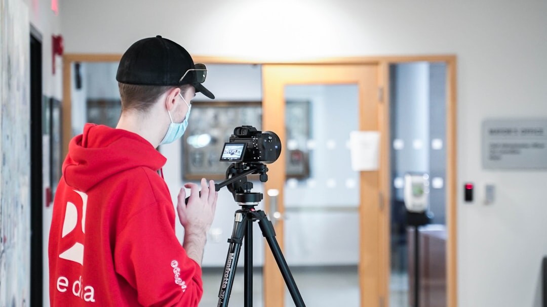 Student operating a professional broadcast camera on a pedestal