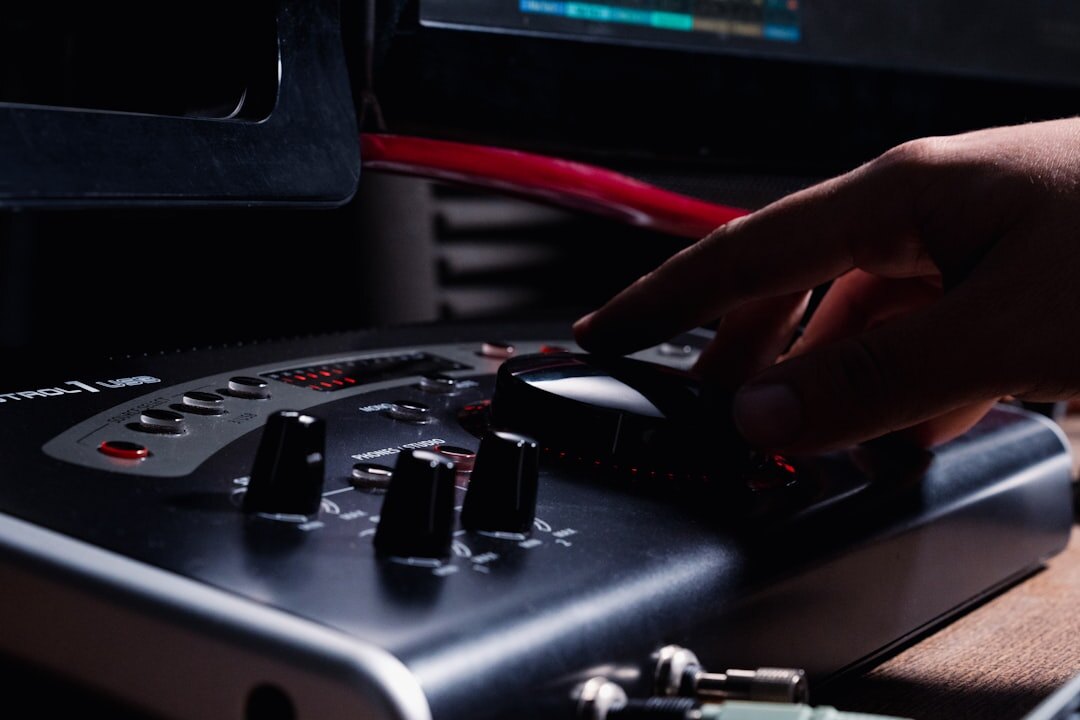Hands operating a professional video switcher panel with multiple buttons