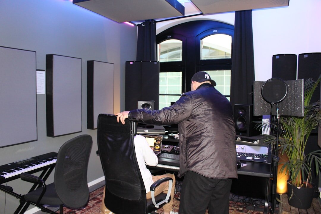 Instructor mentoring a student at a live production control desk